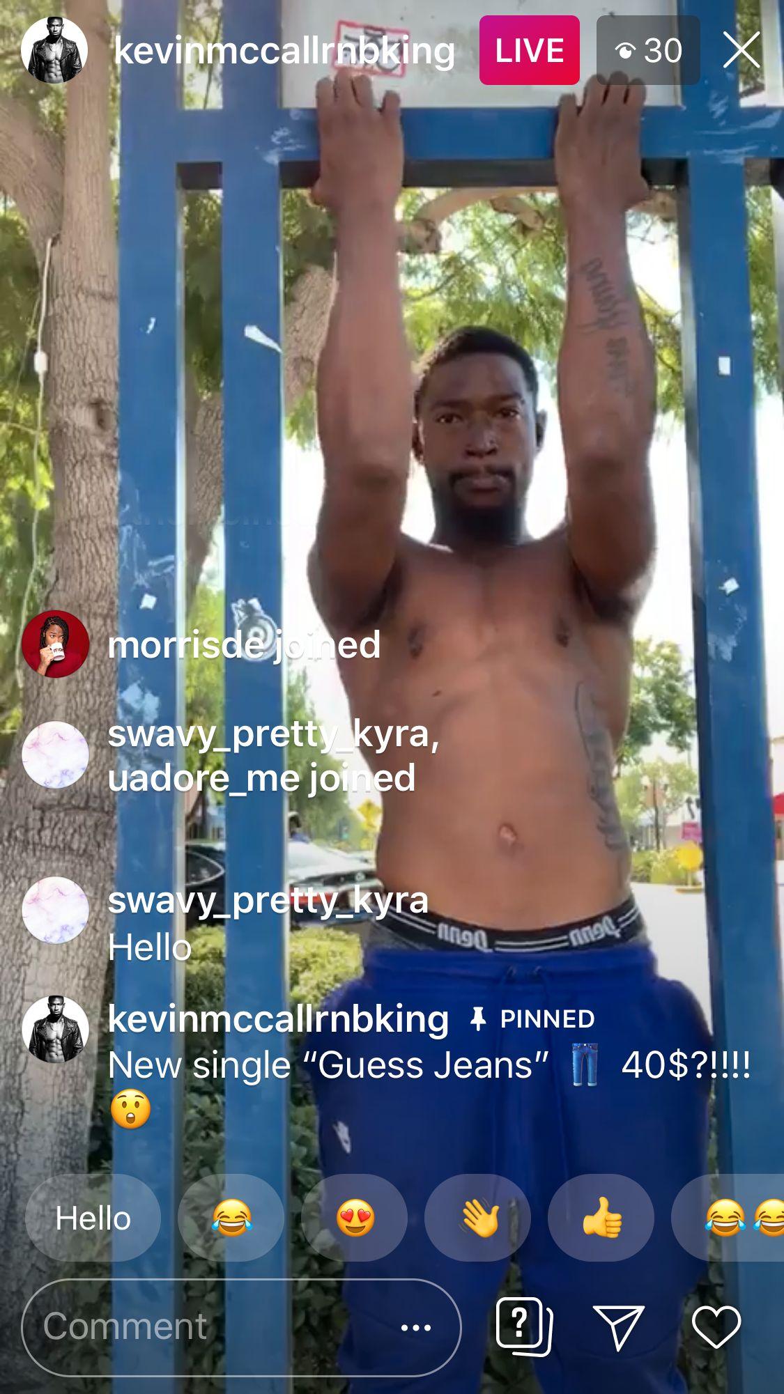 Kevin McCall doing a pull-up on a blue bar during an Instagram Live stream