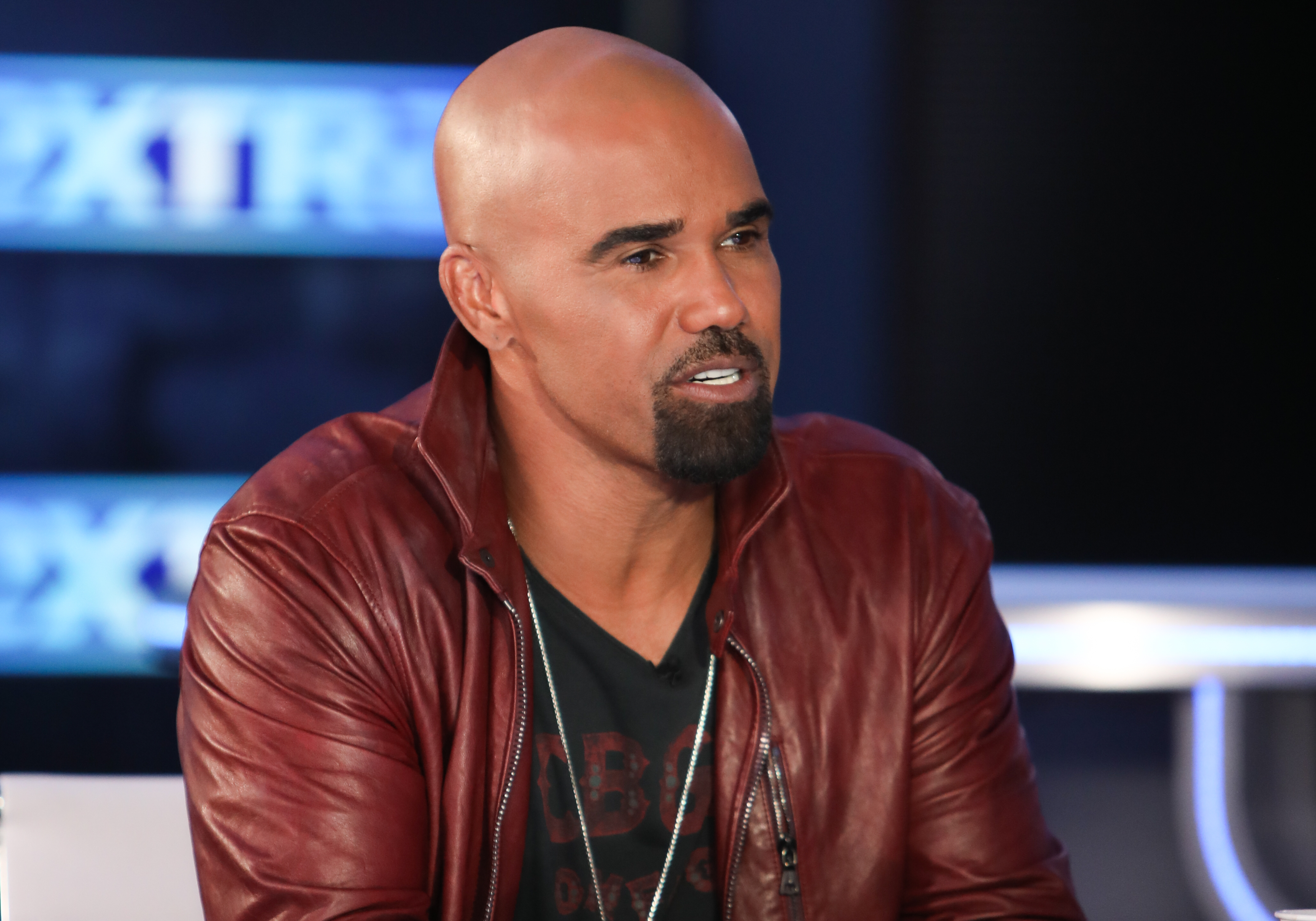 Shemar Moore in a maroon leather jacket during a television interview