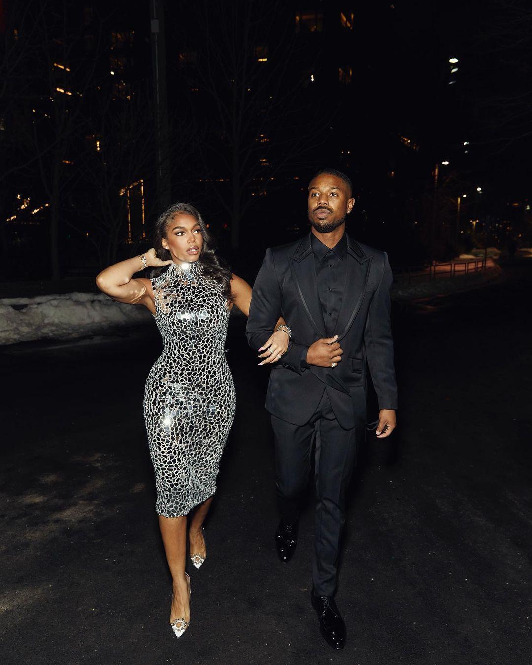 Michael B. Jordan and Lori Harvey walking together at night in an urban setting