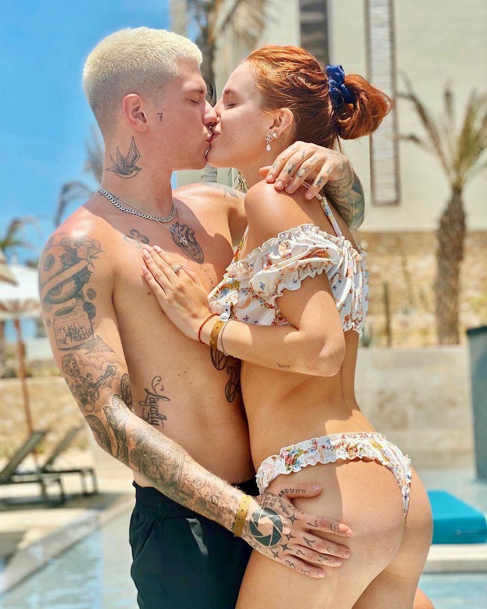 Couple kissing by a pool at a beachfront location