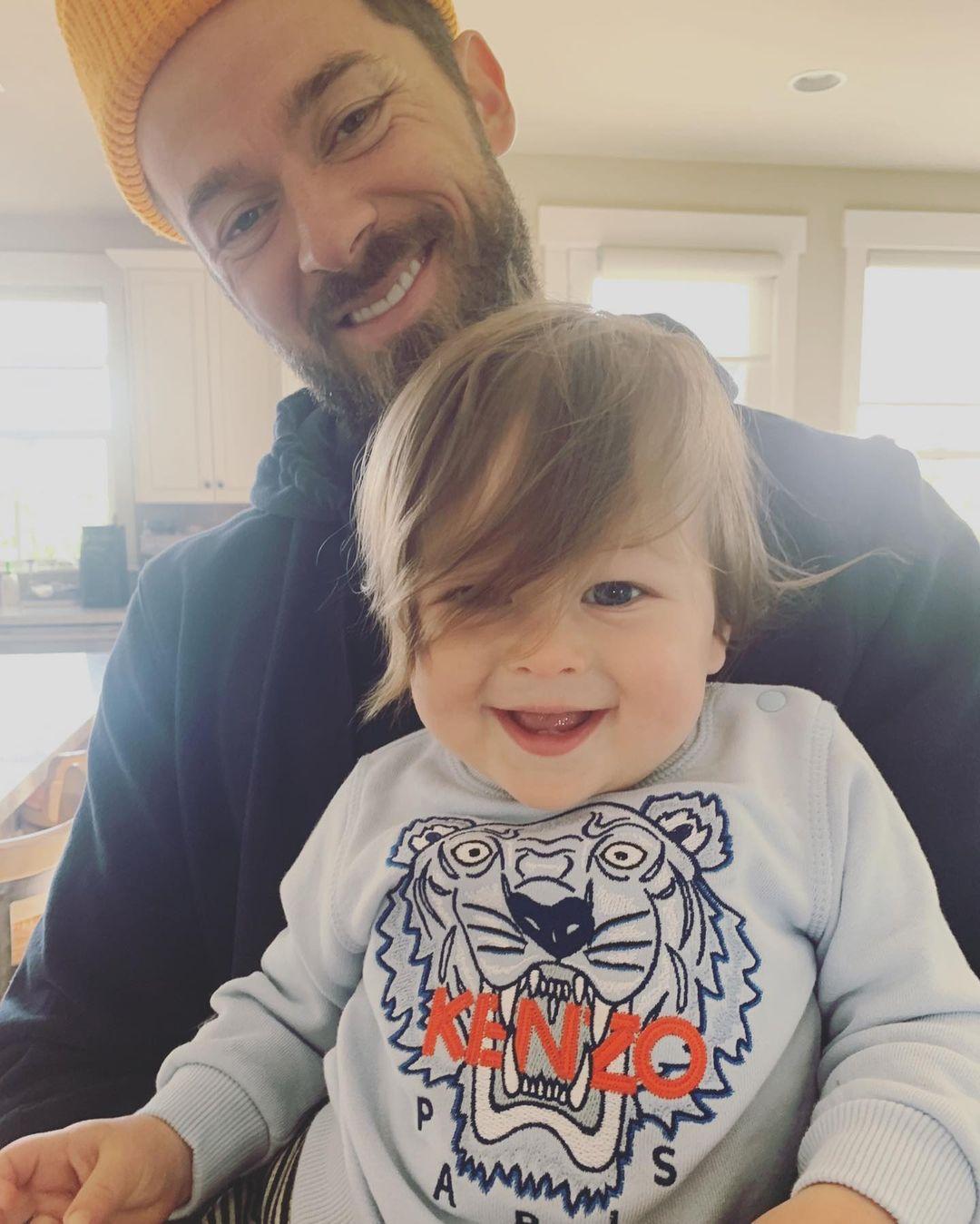 Nikki Bella and her young son smiling together indoors