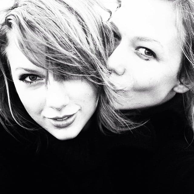 Two women posing close together for a black and white portrait photo