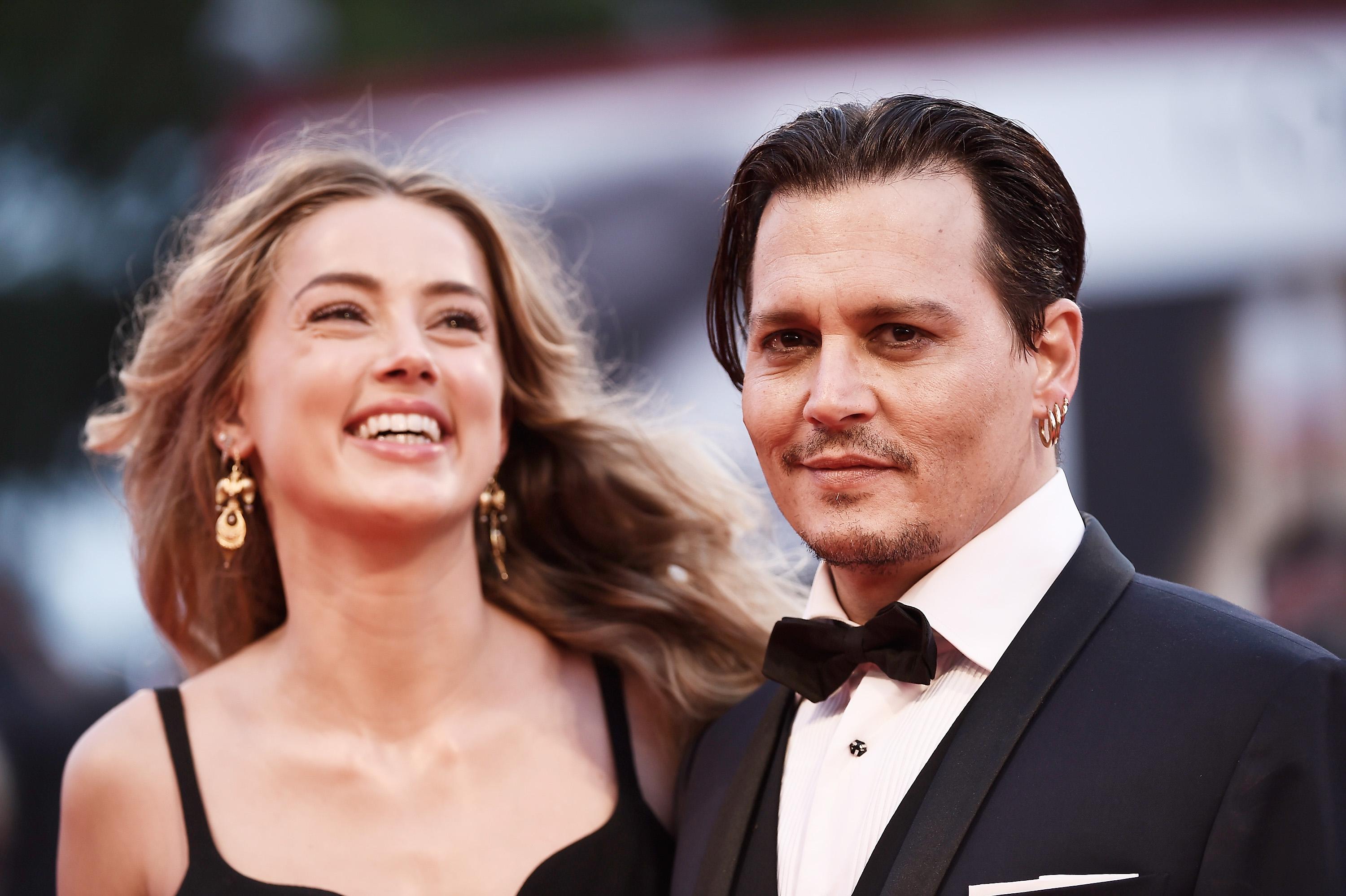 Two people in formal attire at a red carpet event