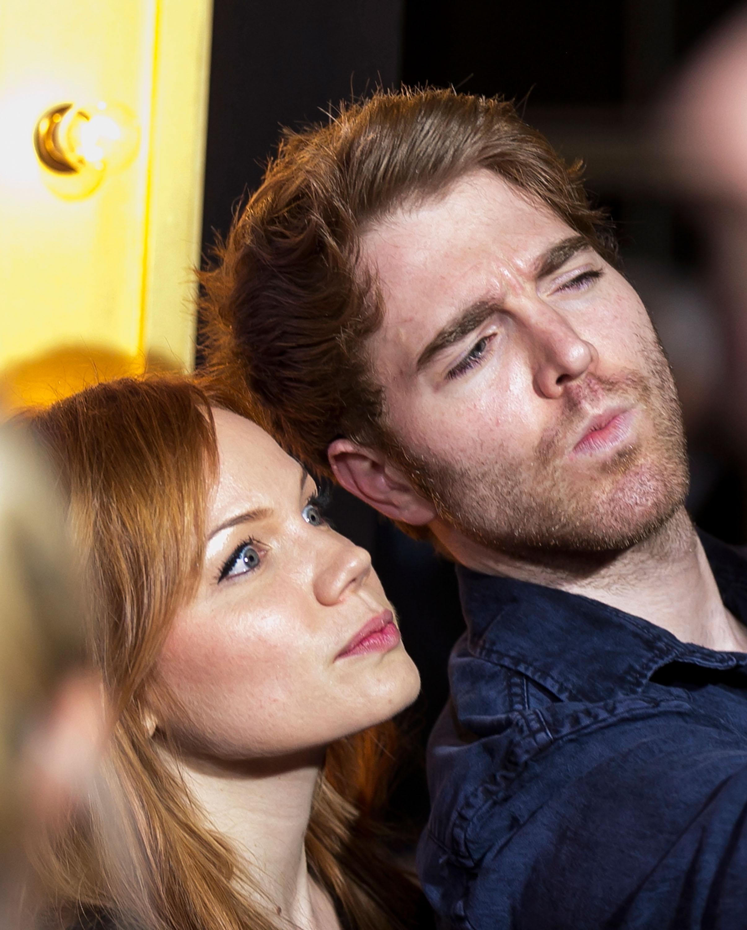 Shane Dawson and a woman with reddish-brown hair looking upward together