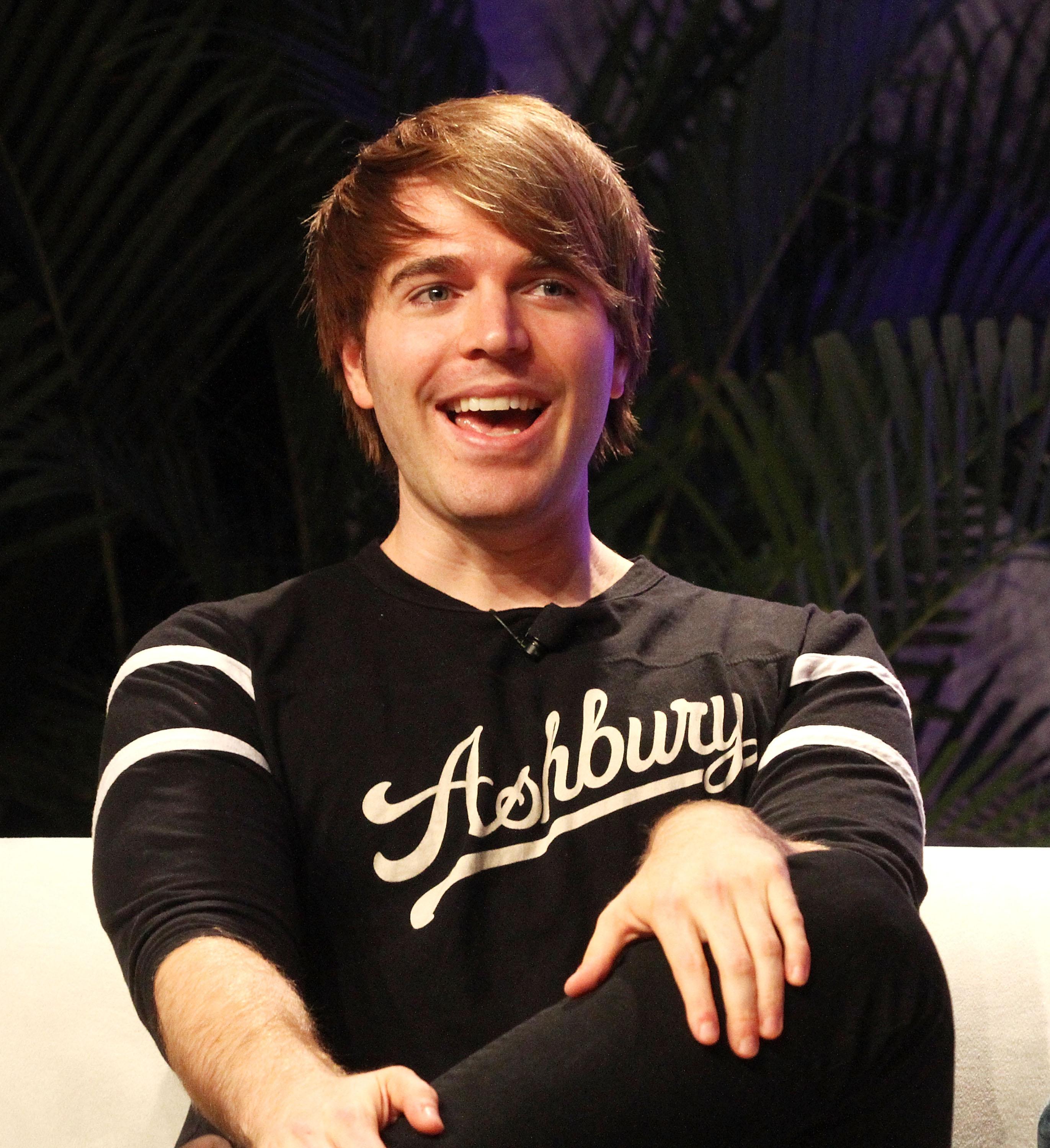 Shane Dawson smiling while wearing an Ashbury branded shirt during an interview