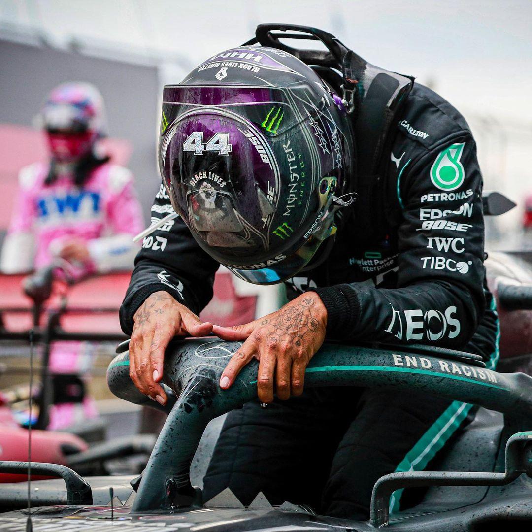 Lewis Hamilton holds his racing helmet after a Formula 1 victory