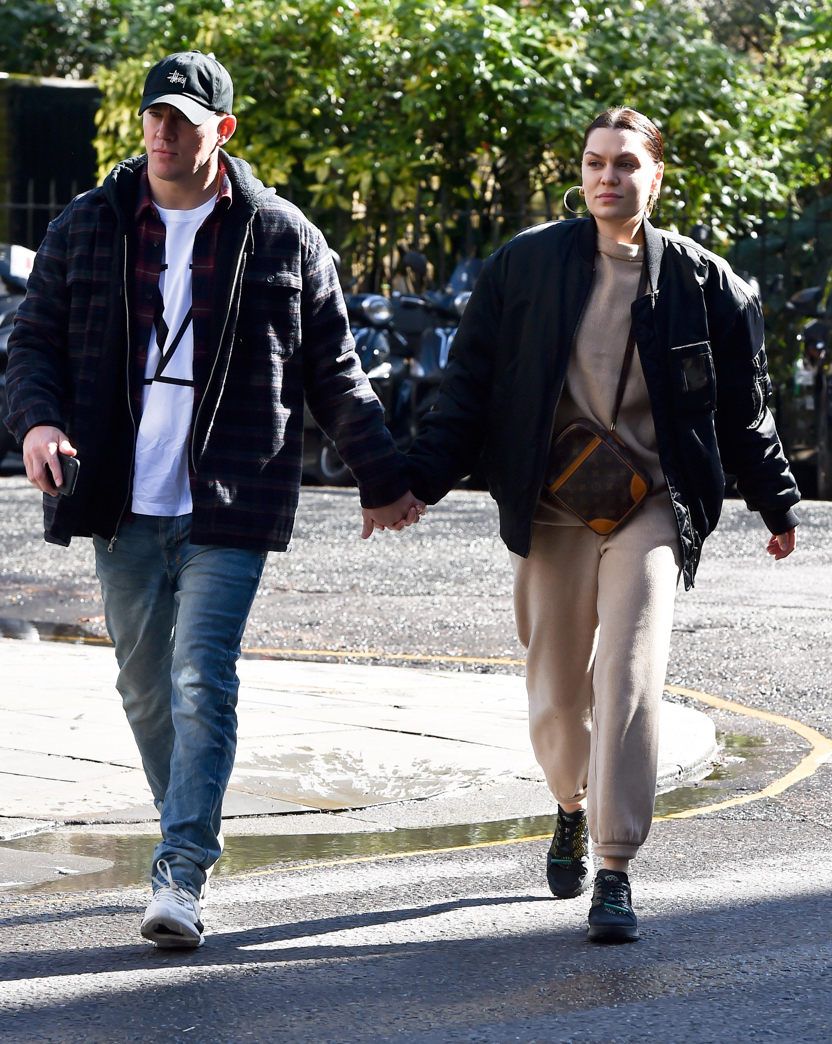 Jenna Dewan and Steve Kazee walking hand-in-hand on a street