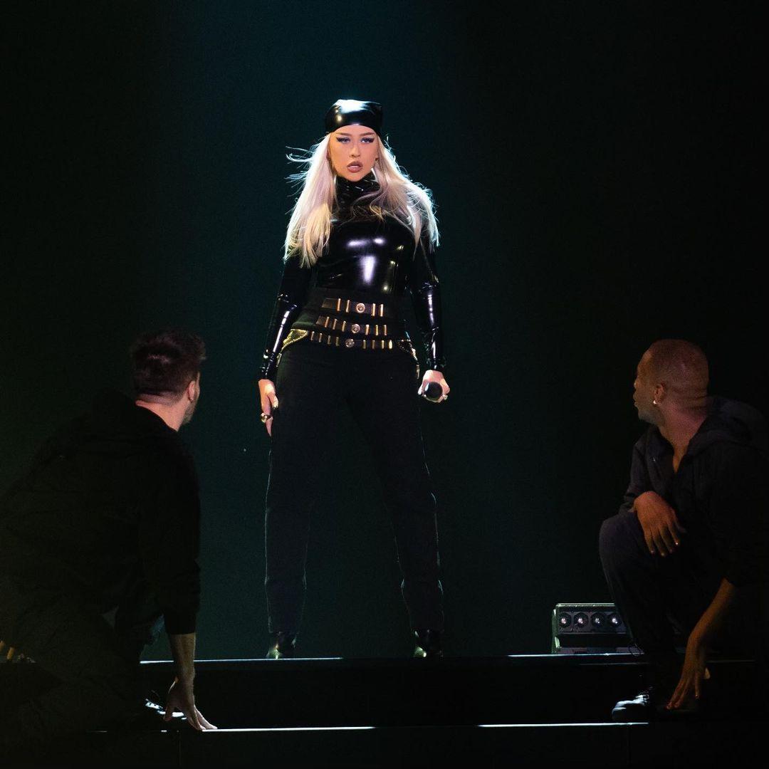 Christina Aguilera performs in a black latex outfit on stage in Las Vegas.