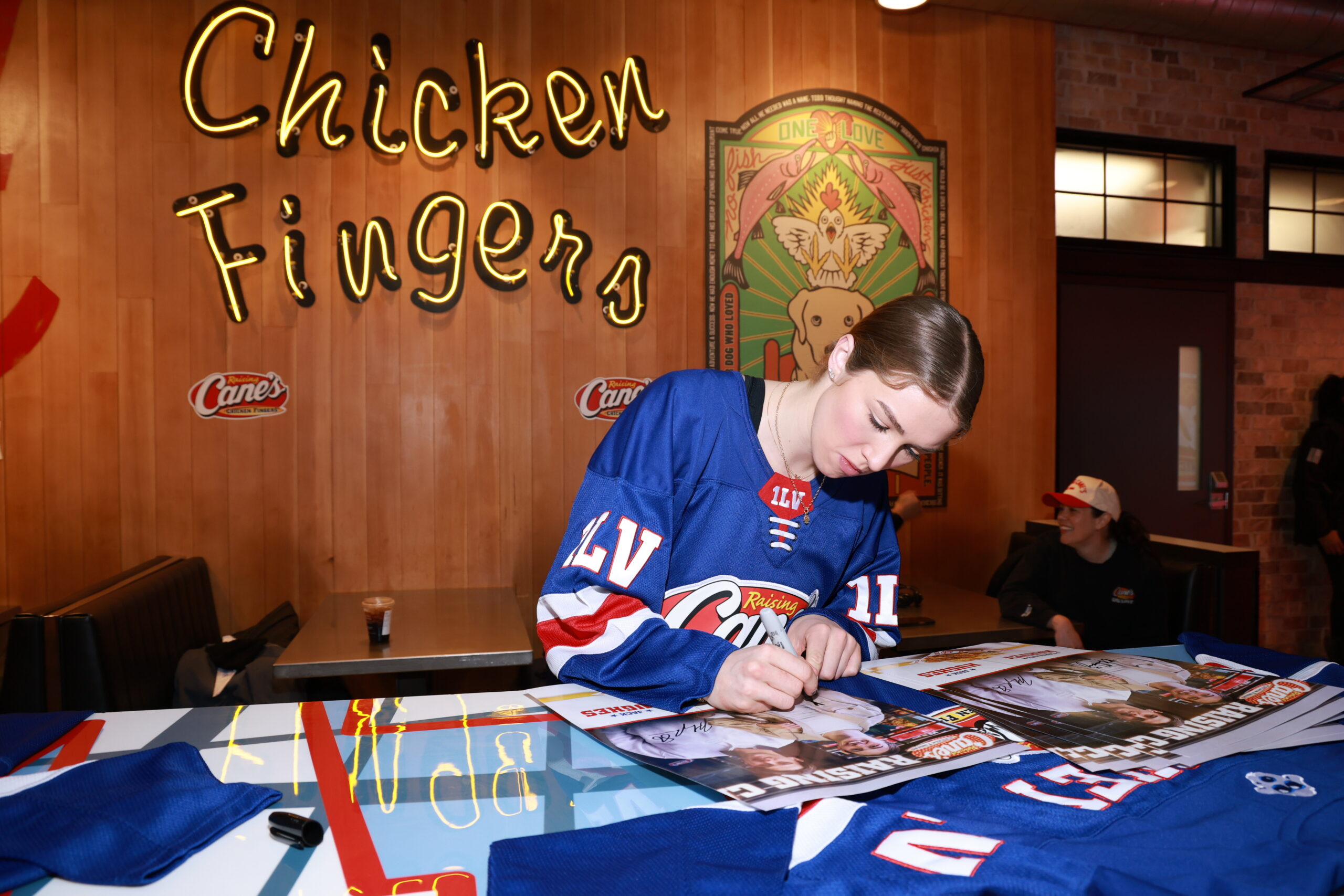 Caroline Harvey signing a jersey